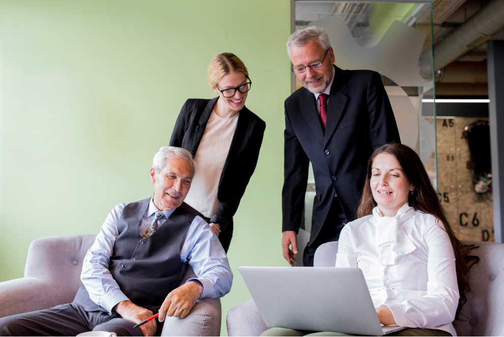 smiling confident businesswoman showing laptop her coworker office